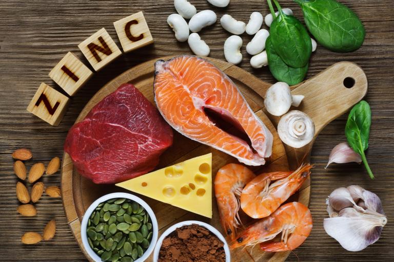 A platter of zinc-rich foods, including red meat, cheese, seafood and pumpkin seeds.